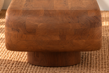 Load image into Gallery viewer, Rolly acacia wood coffee table in natural brown with rounded edges, open shelf, and two cylindrical pedestal feet.
