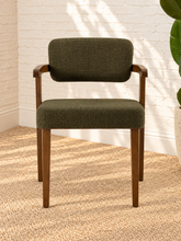 Load image into Gallery viewer, Royce dining armchair with deep olive textured upholstery, curved cushioned back, and walnut-finished solid rubberwood frame.

