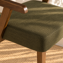 Load image into Gallery viewer, Royce dining armchair with deep olive textured upholstery, curved cushioned back, and walnut-finished solid rubberwood frame.
