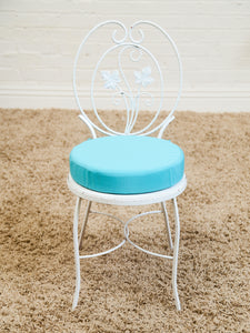 Vintage Wrought Iron Patio Dining Table with Leaf Motif Aqua Cushions and Glass Top