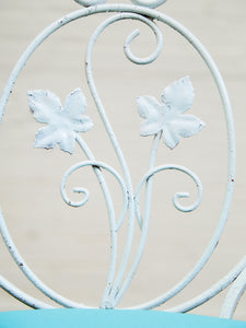 Vintage Wrought Iron Patio Dining Table with Leaf Motif Aqua Cushions and Glass Top