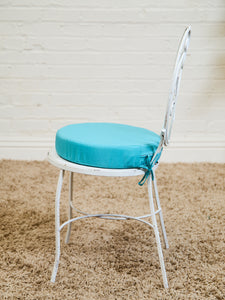 Vintage Wrought Iron Patio Dining Table with Leaf Motif Aqua Cushions and Glass Top