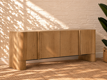 Load image into Gallery viewer, Sadie natural oak four-door credenza with rounded edges, integrated legs, white oak veneer, and interior shelving.
