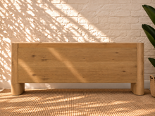 Load image into Gallery viewer, Sadie natural oak four-door credenza with rounded edges, integrated legs, white oak veneer, and interior shelving.
