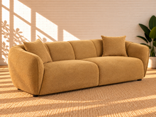 Load image into Gallery viewer, Image 2 of 5: Savino upholstered sofa in Warm Ochre fabric with rounded shelter arms, channel back detailing, and broad cushioned seats
