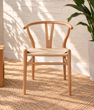 Load image into Gallery viewer, Sculptural blonde tone dining chair with curved wood back, central cutout splat and natural woven cord seat.
