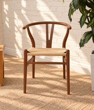 Load image into Gallery viewer, Sculptural walnut-tone dining chair with curved open back, central wood splat and natural woven cord seat.
