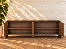 Load image into Gallery viewer, Sloan Minimalist Buffet Credenza in Warm Walnut with four doors, interior shelving, and tapered feet
