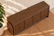 Load image into Gallery viewer, Sloan Minimalist Buffet Credenza in Warm Walnut with four doors, interior shelving, and tapered feet
