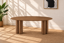 Load image into Gallery viewer, Stella sculptural oval dining table in walnut with oak veneer top and rounded three-column pedestal bases
