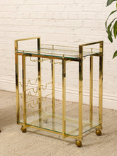 Load image into Gallery viewer, Vintage Hollywood Regency Brass Bar Cart with Glass Shelves
