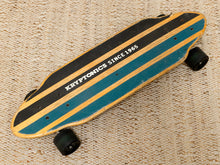 Load image into Gallery viewer, A vintage Kryptonics skateboard with teal and black striped grip tape on a natural wood deck, resting on a beige woven fabric background.
