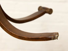 Load image into Gallery viewer, A close-up of a curved wooden chair arm or support leg with visible wear, scratches, and a rough broken end, photographed against a light off-white background.
