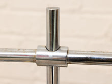 Load image into Gallery viewer, Close-up of a polished metal crossbar joint with a vertical post, showing a brushed silver finish and some minor rust on the horizontal bars against a light beige background.
