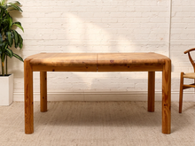 Load image into Gallery viewer, Vintage Rainer Daumiller solid pine dining table with rounded corners and thick cylindrical legs.

