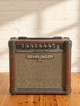 Load image into Gallery viewer, Behringer Ultracoustic AT108 acoustic instrument amplifier with brown cabinet, front speaker grille, microphone and instrument inputs, and EQ controls.

