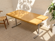 Load image into Gallery viewer, Mid-century style rectangular dining table with blonde wood top and sculptural chrome tubular Y-shaped legs.
