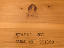 Load image into Gallery viewer, Close-up of a wooden surface with a printed Lane Atlavista logo and stamped text reading STYLE NO 861 and SERIAL NO 551180.
