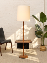 Load image into Gallery viewer, Vintage Richard Barr for Laurel floor lamp with walnut stem, integrated square wood table, round base, dark sculptural accent, and tall cylindrical shade.
