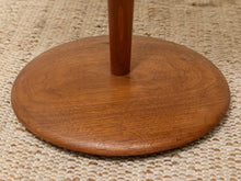 Load image into Gallery viewer, Close-up of a round wooden stand base with a vertical leg, made of medium brown wood grain, resting on a beige woven rug.
