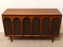 Load image into Gallery viewer, Mid-century modern wooden sideboard cabinet with four arched cane-screen doors, shown against a white brick wall and light woven rug.
