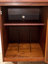 Load image into Gallery viewer, Open wooden cabinet interior with two dark metal wire shelf dividers, a wood shelf, and a dark back panel.

