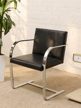 Load image into Gallery viewer, Mies van der Rohe Flat Bar Brno chair with polished chrome cantilever frame and black leather upholstered seat and back.
