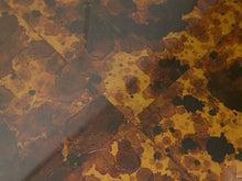 Load image into Gallery viewer, A close-up of a textured surface featuring an abstract pattern of organic shapes in black, deep brown, and golden yellow, resembling a vintage stained-glass or stained-water look.
