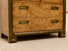 Load image into Gallery viewer, Close-up of a wooden chest of drawers with two front drawers, a prominent burl wood grain finish, and brass pull handles, standing on a carpeted floor.
