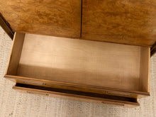 Load image into Gallery viewer, A close-up top-down view of a wooden chest or cabinet with two drawers pulled open, showing the light natural wood drawer interiors and darker wood exterior with visible grain.
