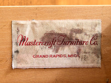 Load image into Gallery viewer, A close-up of a worn fabric brand label reading 'Mastercraft Furniture Co. GRAND RAPIDS, MICH.
