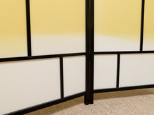 Load image into Gallery viewer, A close-up of a Japanese-style folding screen with white and yellow gradient panels framed in black metal, set against a beige carpeted floor.
