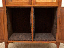 Load image into Gallery viewer, Close-up of the interior of a wooden cabinet with two open doors, showing dark brown carpeted shelves and a central divider, photographed against a light neutral background.
