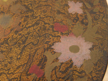 Load image into Gallery viewer, Close-up of a decorative surface with an ornate gold and dark patterned background, overlaid with pale pink floral shapes and a few muted red accents.
