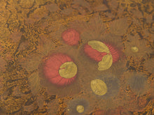 Load image into Gallery viewer, A close-up of a textured surface with a repeating floral pattern in muted gold, brown, and red tones, featuring oval and round flower motifs with pale yellow centers.

