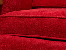 Load image into Gallery viewer, Close-up of a red textured fabric upholstery, showing the seat cushion and backrest with deep channel stitching.

