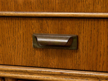 Load image into Gallery viewer, Close-up of a warm medium-brown wooden drawer front with a dark metal pull handle.
