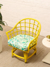Load image into Gallery viewer, Image 8 of 20: Set of four vintage bright yellow rattan barrel chairs with floral cushions, alternate view 3
