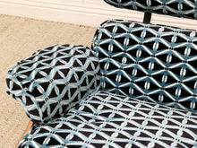 Load image into Gallery viewer, Close-up of upholstered furniture with a black, white, and light blue geometric lattice pattern, shown on a chair or sofa in an indoor room with beige carpet and white baseboard visible.
