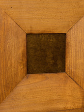 Load image into Gallery viewer, Close-up of a wooden frame or box corner with a dark brown square insert in the center, showing warm wood grain and a textured brown surface.
