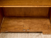 Load image into Gallery viewer, Close-up of the interior of a wooden cabinet or shelf with a warm medium-brown wood finish, showing the grain and wear marks on the bottom shelf.
