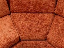 Load image into Gallery viewer, Close-up of an orange-brown textured fabric upholstered armchair, showing the woven material and seat cushion details.
