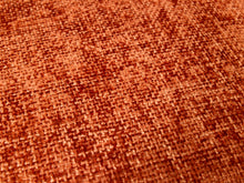 Load image into Gallery viewer, A close-up of a woven fabric texture in a warm rust-orange color, showing the detailed knit pattern.
