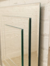 Load image into Gallery viewer, Two large rectangular mirrored glass panels leaning against a white brick wall.
