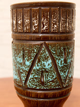 Load image into Gallery viewer, A close-up of a ceramic vase with a textured brown glaze and turquoise blue geometric patterns, set against a neutral beige background.

