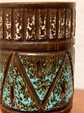 Load image into Gallery viewer, Close-up of a ceramic vase with a dark brown base and turquoise blue-green glaze accents, featuring carved geometric patterns.
