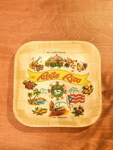 Load image into Gallery viewer, A square wooden serving tray with rounded corners, featuring a colorful hand-painted design of Puerto Rico with the text 'EL CAPITOLIO', 'Riobío Rico', and 'EL MORRO' on a warm wood-grain background.
