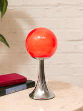 Load image into Gallery viewer, Vintage Space Age table lamp with glossy red glass globe shade and flared chrome pedestal base
