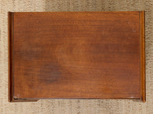 Load image into Gallery viewer, A rectangular wooden box or tray with a warm medium-brown wood grain finish, photographed from directly above on a beige woven rug.

