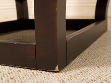 Load image into Gallery viewer, Close-up of a dark brown wooden furniture leg and corner joint on a beige textured carpet.
